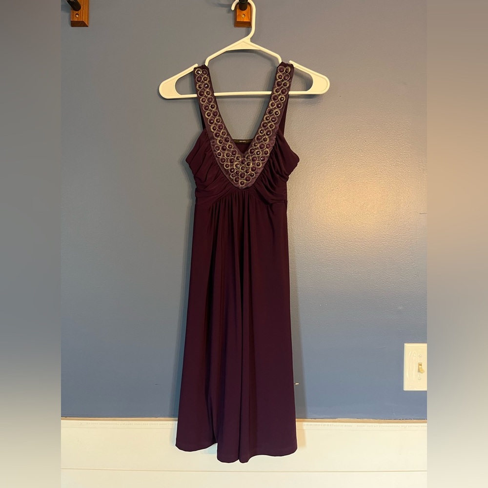 Soprano; plum, cocktail dress with beaded neckline and an a line skirt
